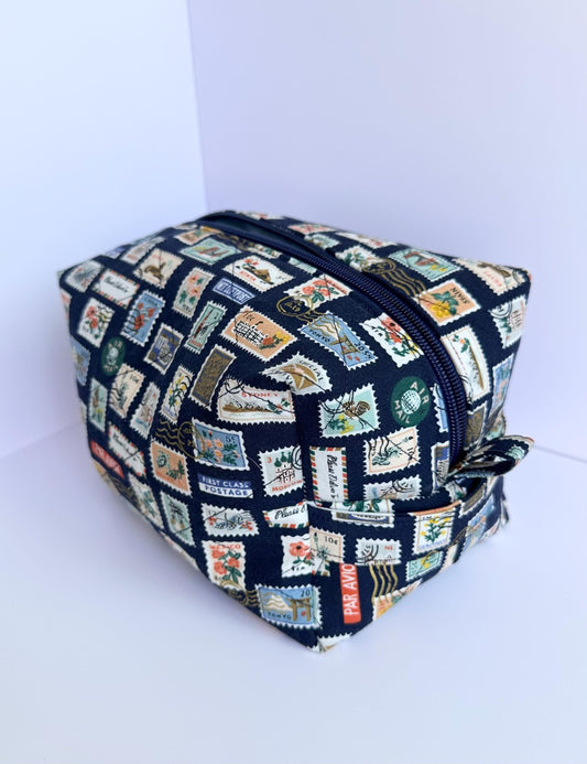 Boxy makeup bag in navy blue stamps