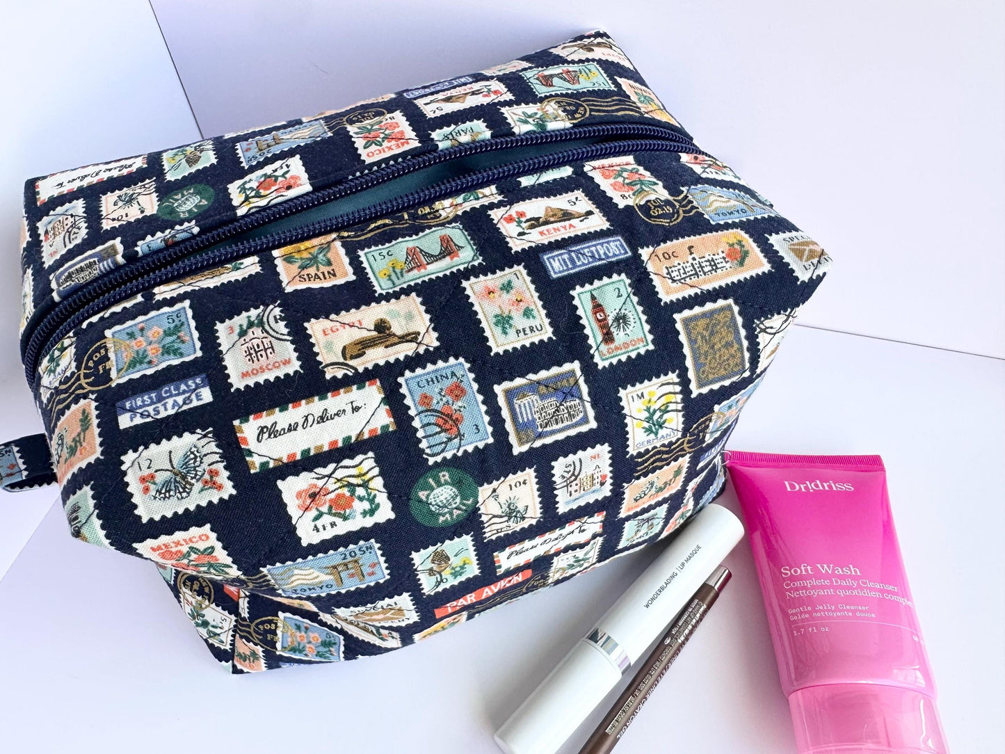Boxy makeup bag in navy blue stamps