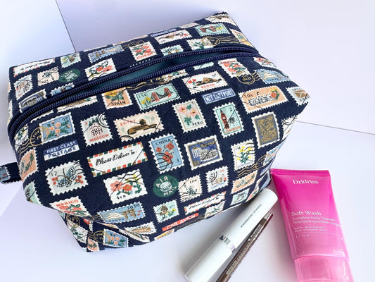 Boxy makeup bag in navy blue stamps