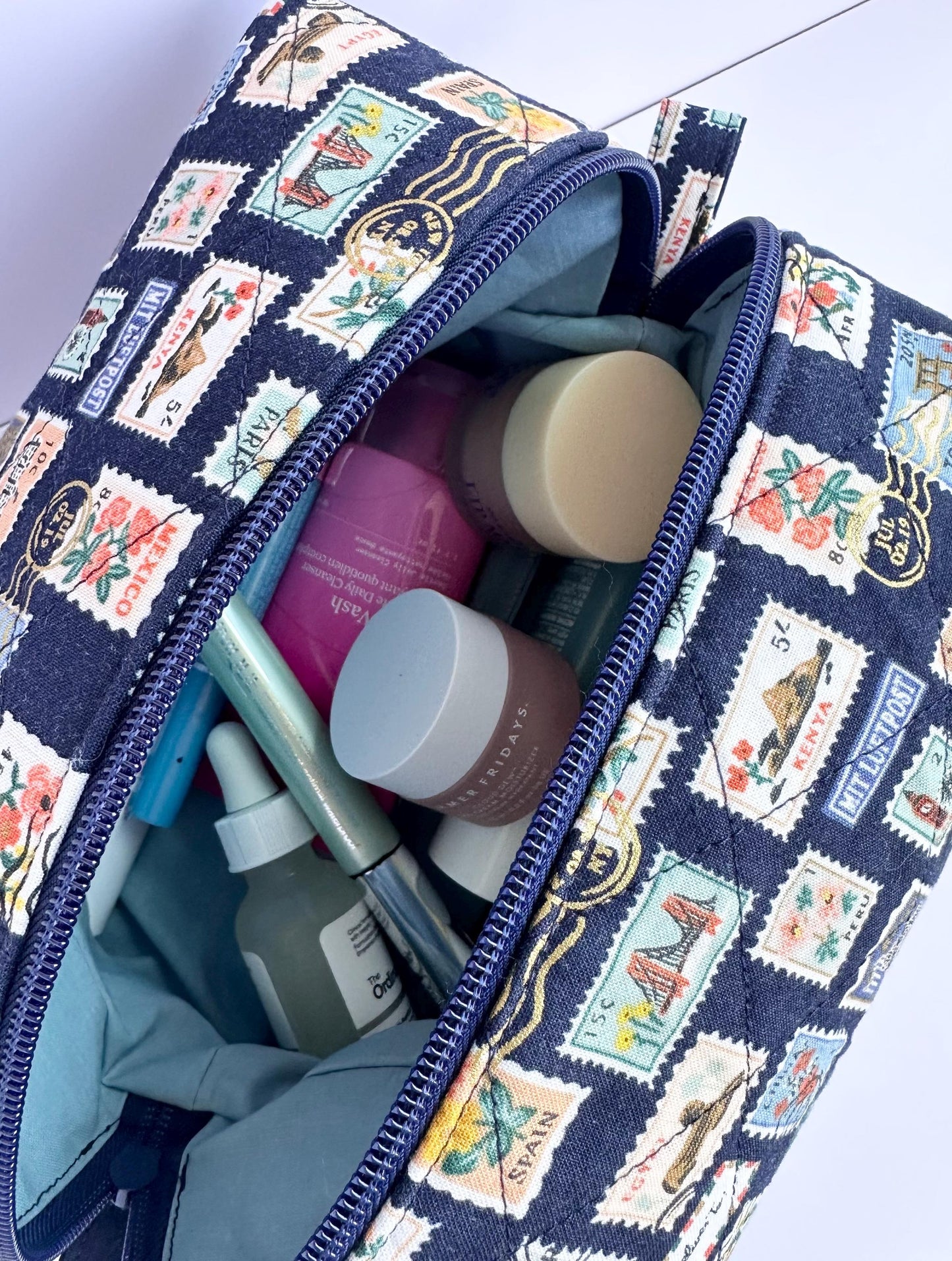 Boxy makeup bag in navy blue stamps