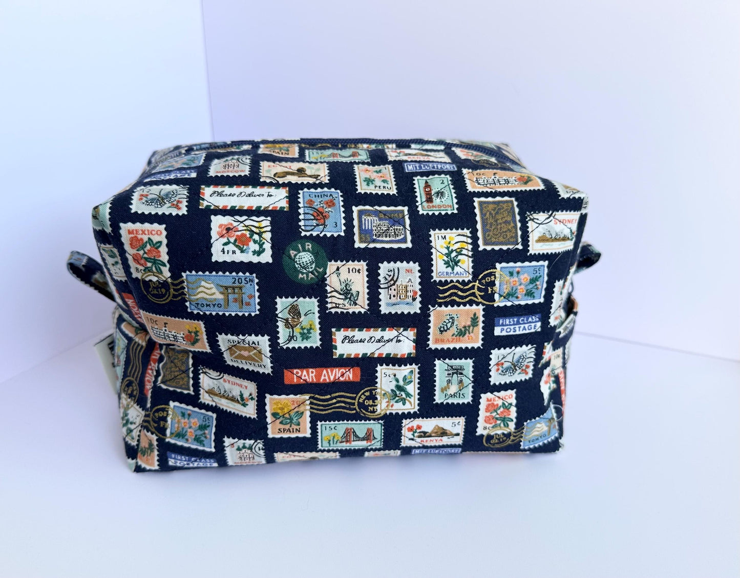 Boxy makeup bag in navy blue stamps