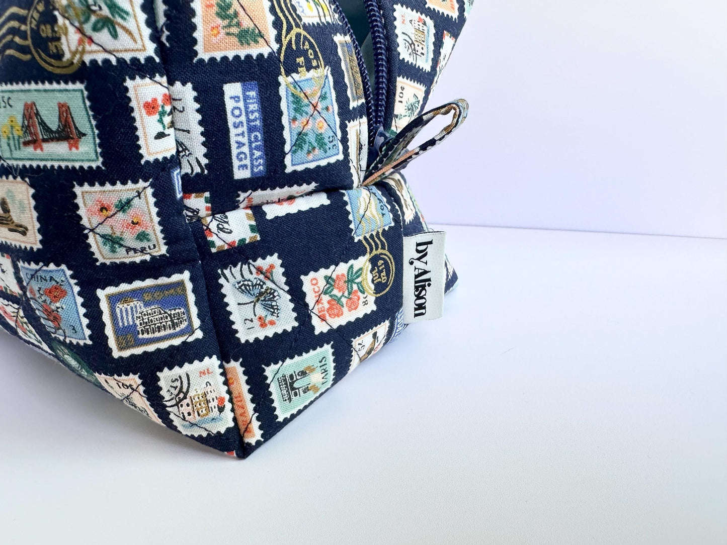 Boxy makeup bag in navy blue stamps