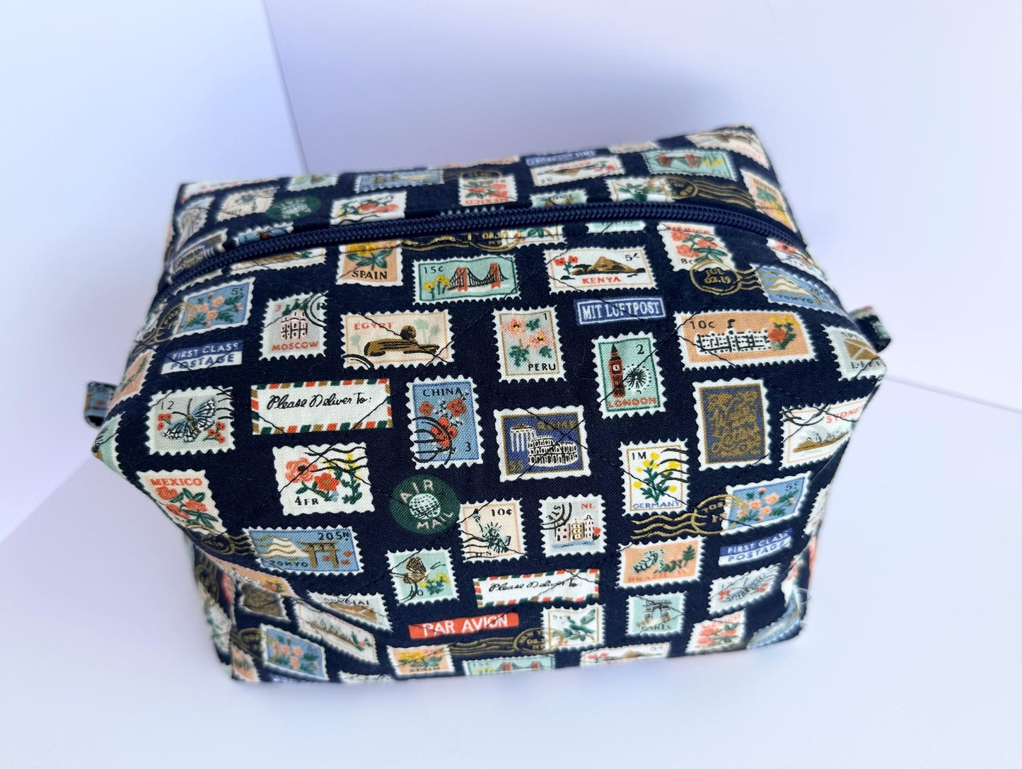 Boxy makeup bag in navy blue stamps