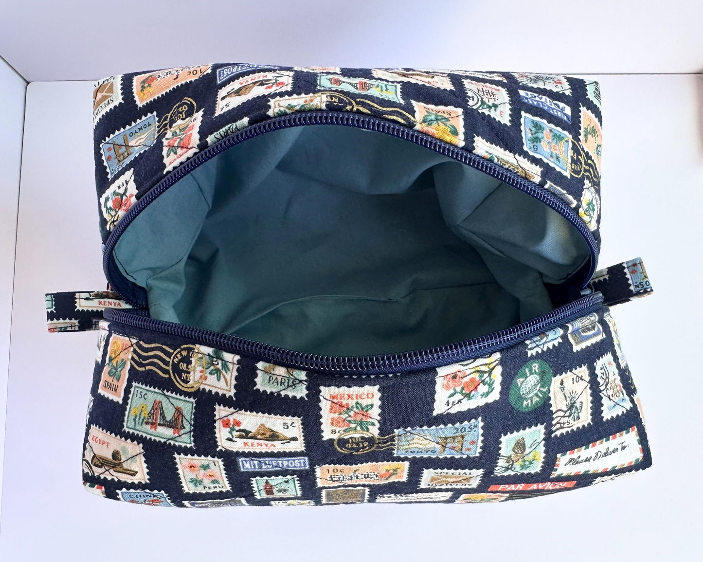 Boxy makeup bag in navy blue stamps