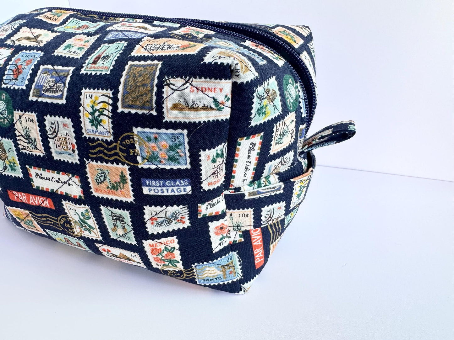 Boxy makeup bag in navy blue stamps